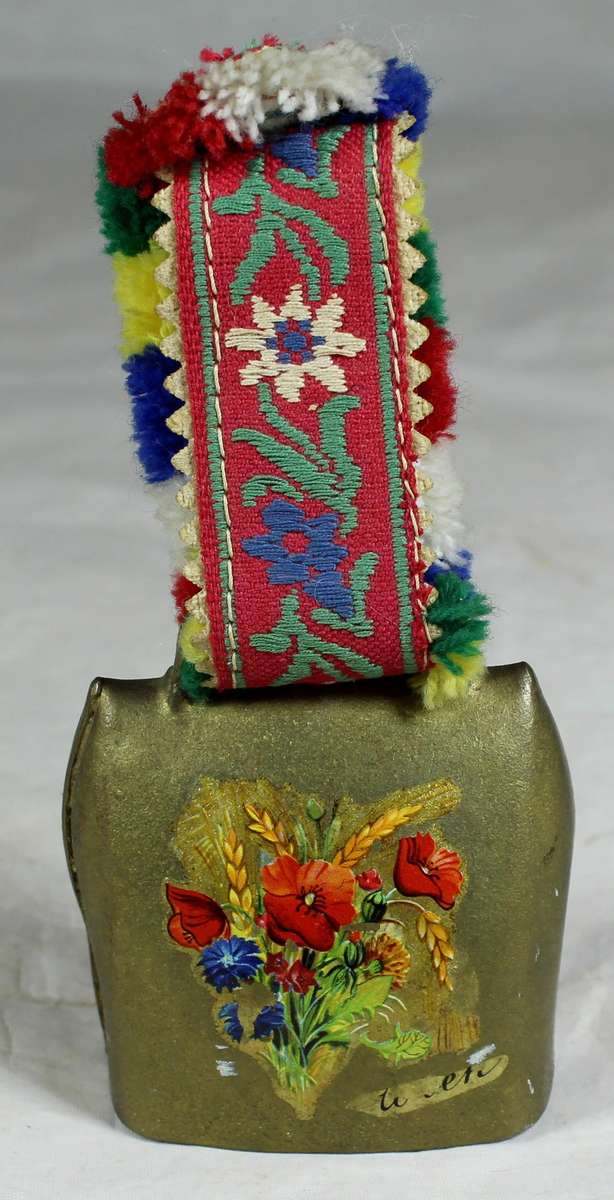 Cow bell with decorative strap