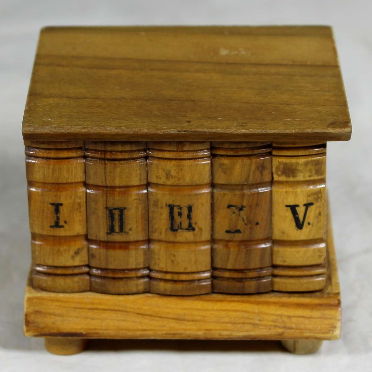 Small wooden box with carved books in front
