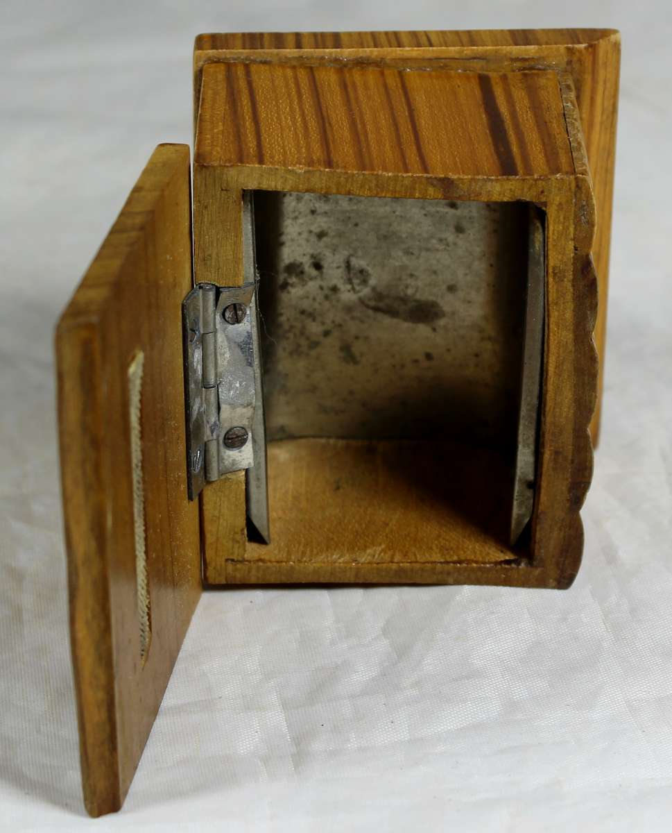 Small wooden box with carved books in front