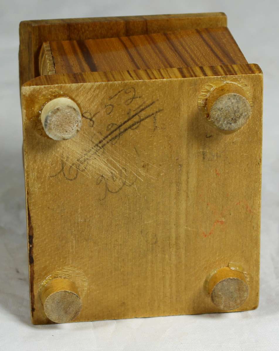 Small wooden box with carved books in front
