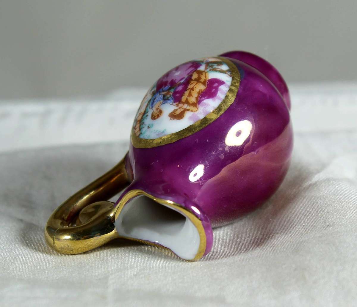 Miniature porcelain jug in maroon