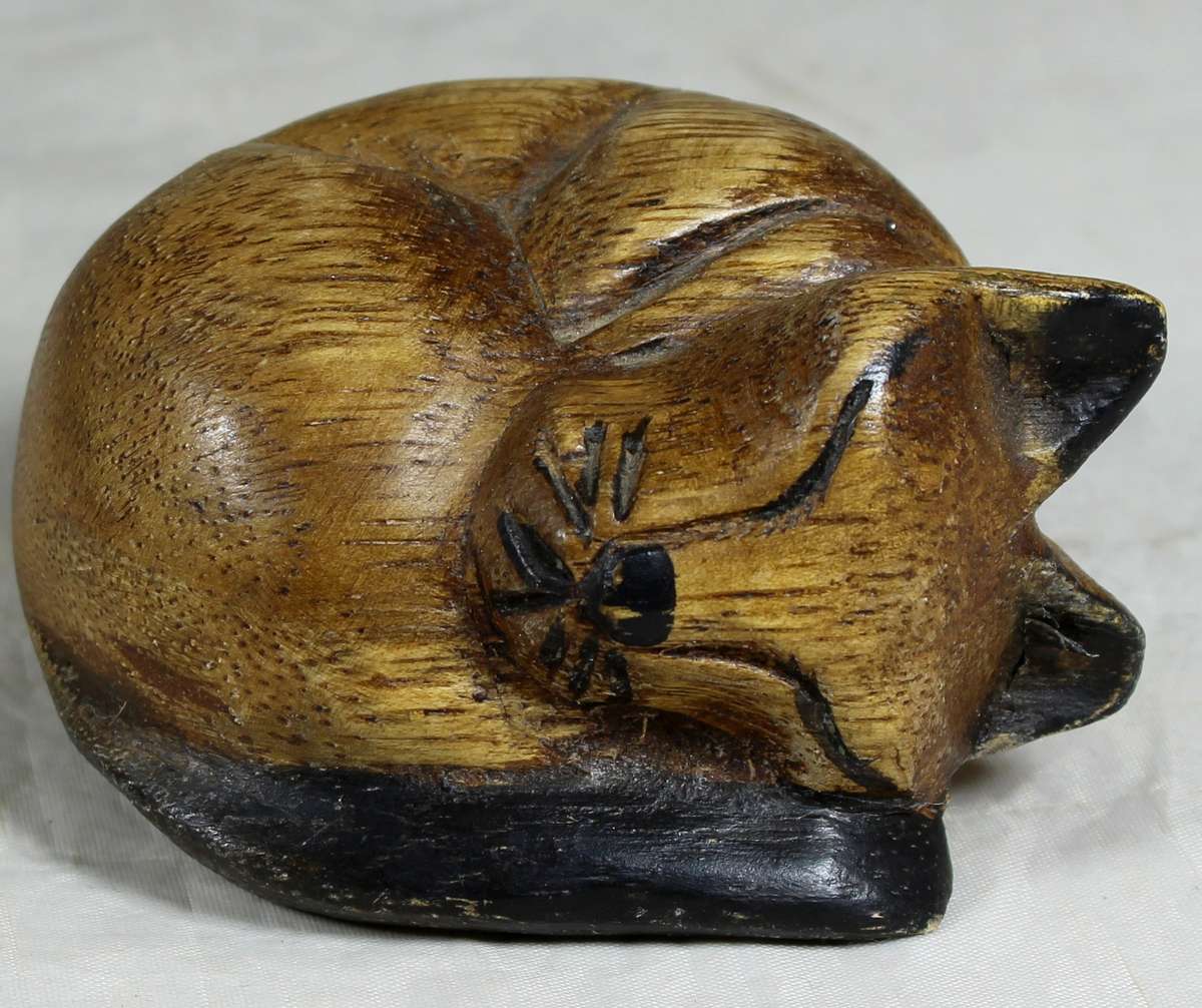 Carved wooden cat sleeping