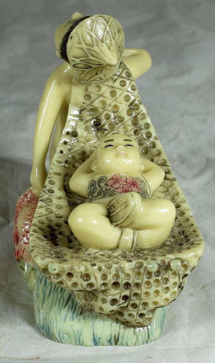 Japanese Netsuke figure - Man holding fish and pulling baby - Resin