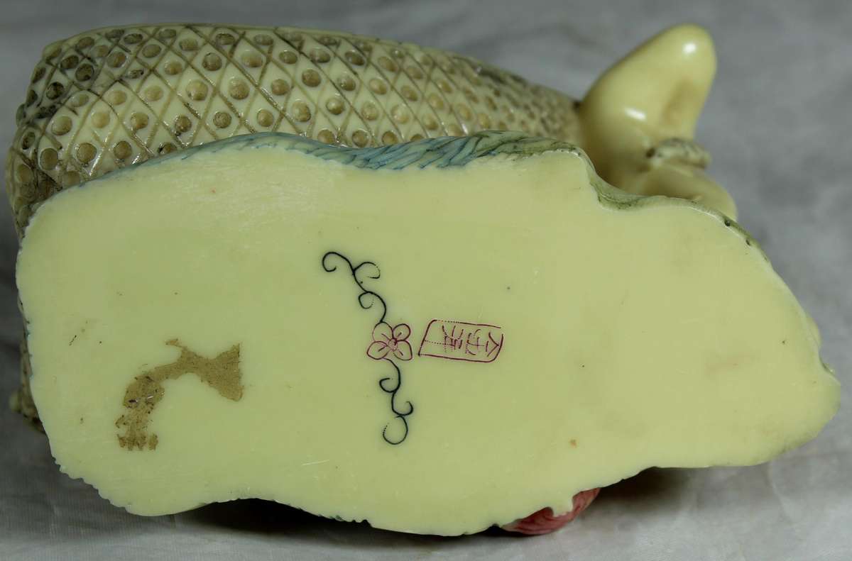 Japanese Netsuke figure - Man holding fish and pulling baby - Resin