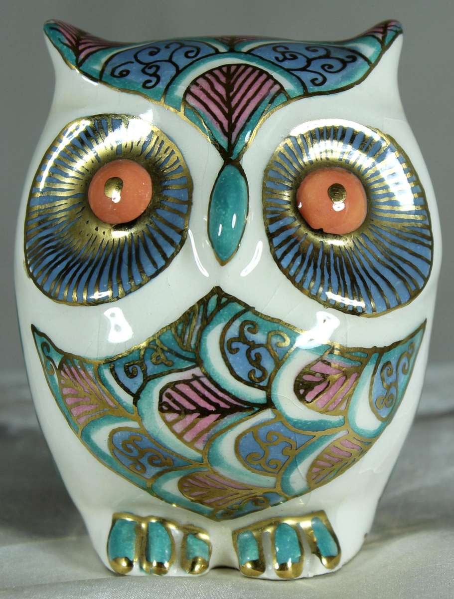 Glazed owl with orange eyes