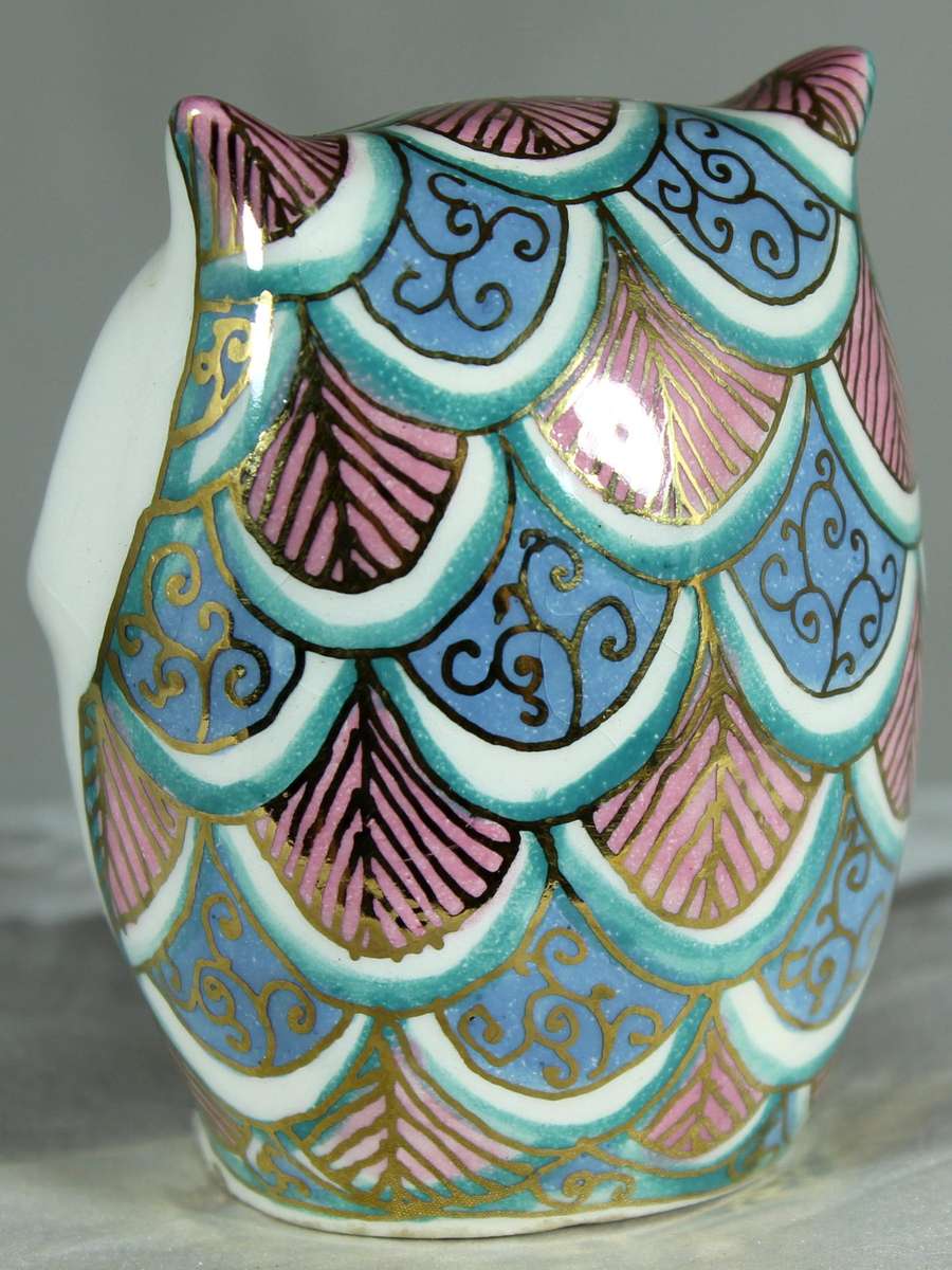 Glazed owl with orange eyes