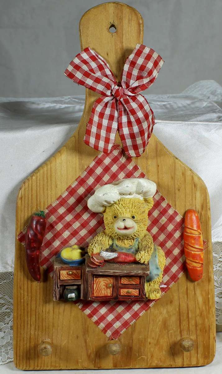 Wooden wall hanging with bear chef in red