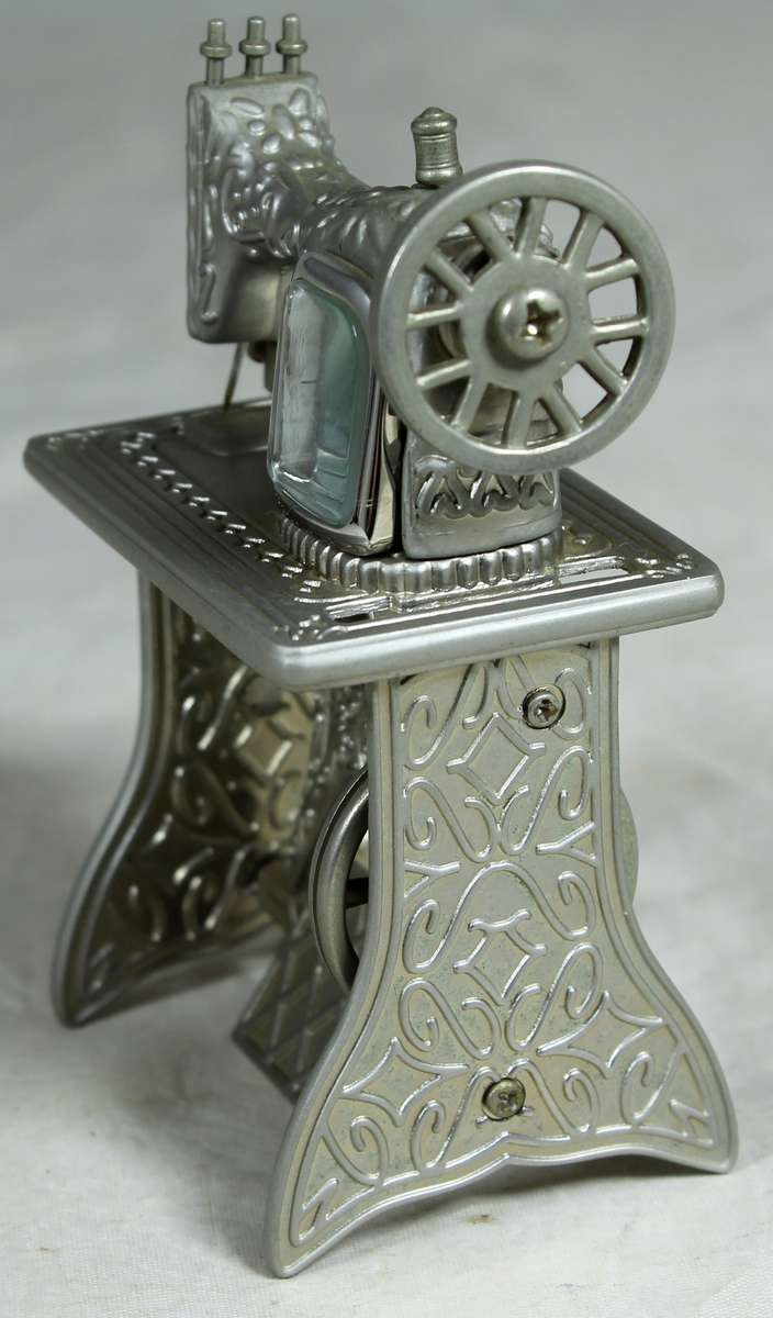 Small metal pedal sewing machine with clock