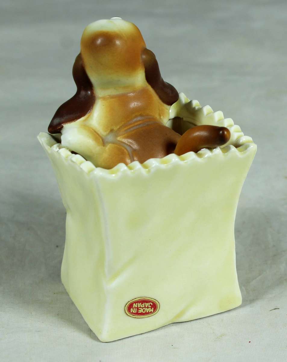 Ceramic puppy in a bin