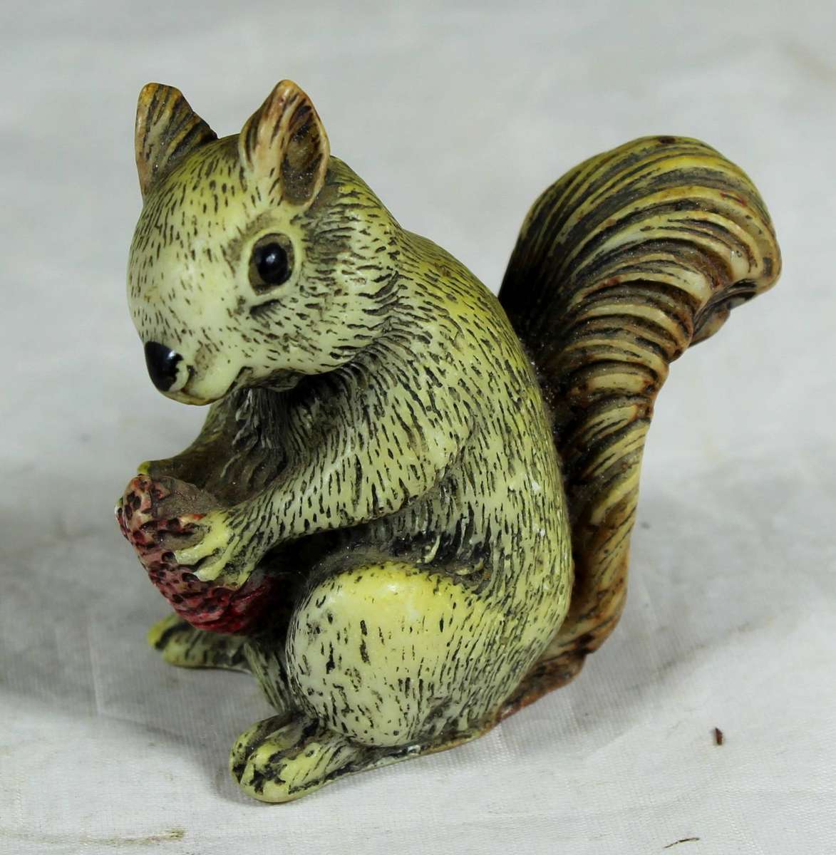Molded squirrel with acorn