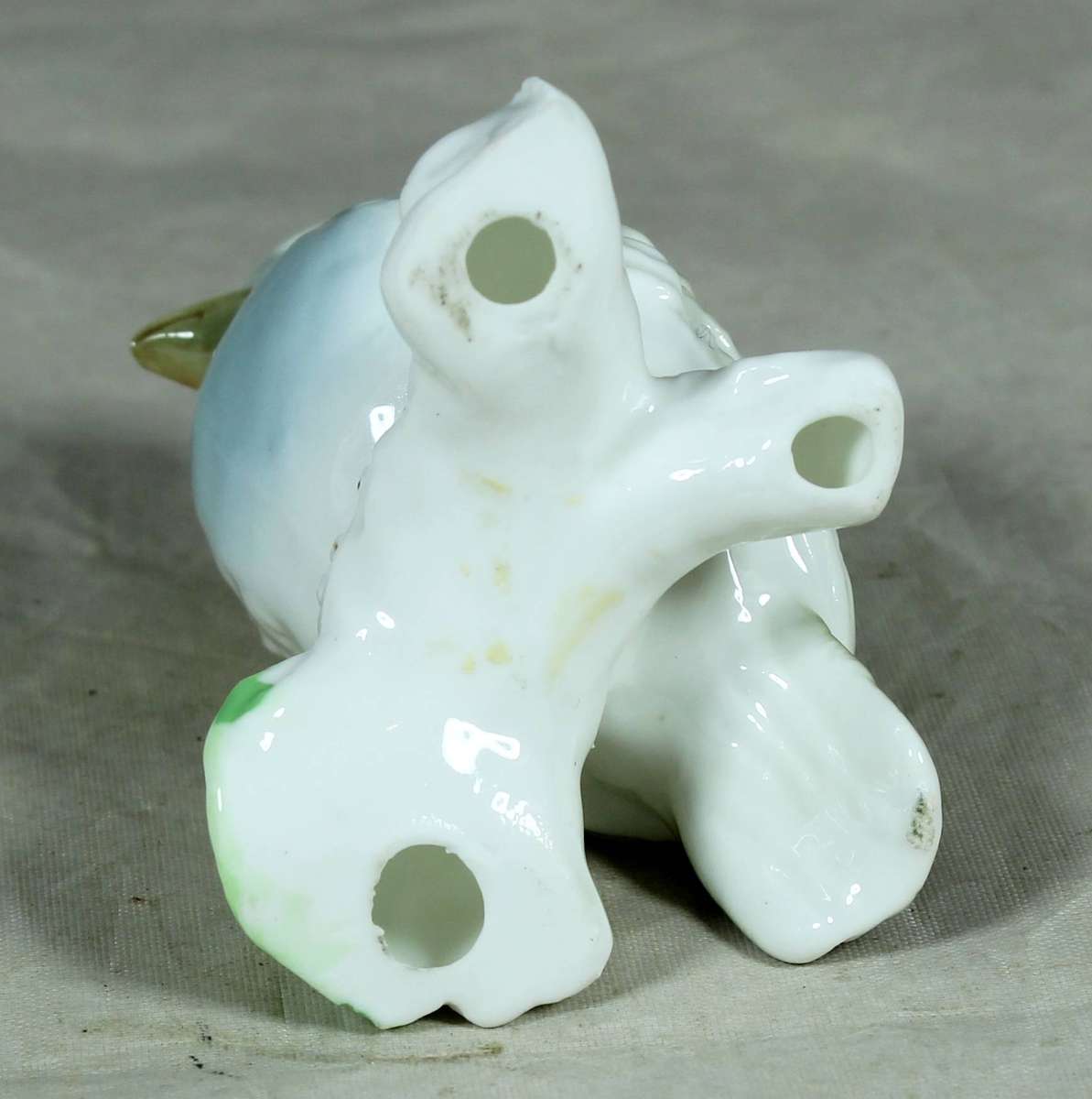 Small glazed bird on a branch