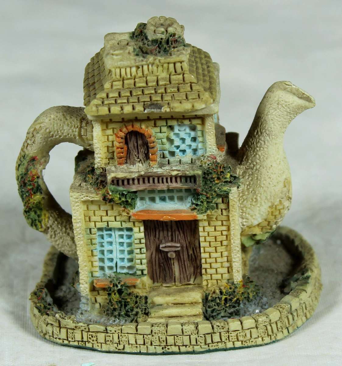Miniature ornamental house in the shape of a tea kettle