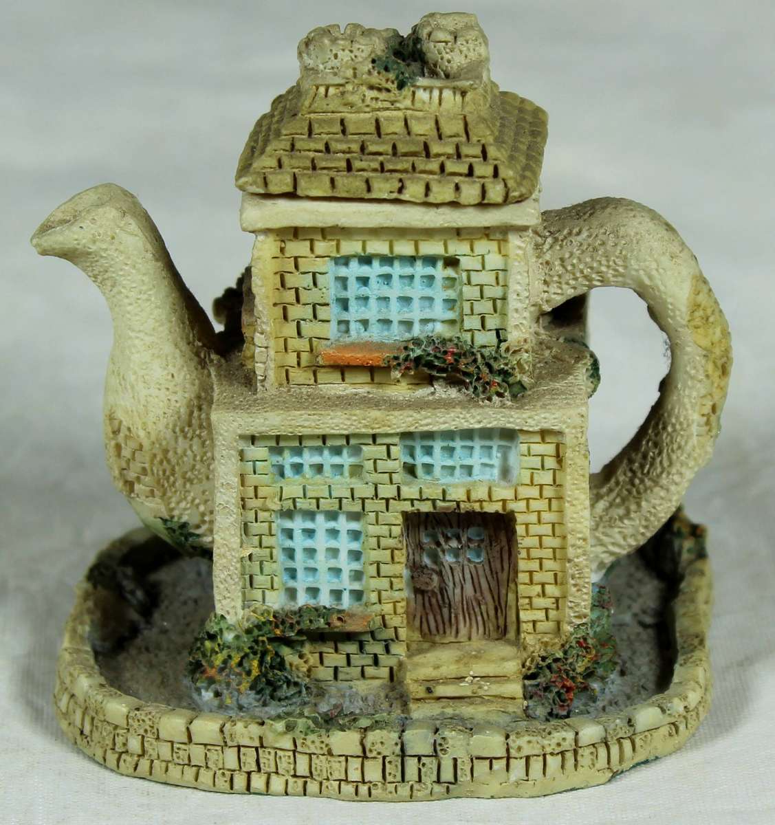 Miniature ornamental house in the shape of a tea kettle