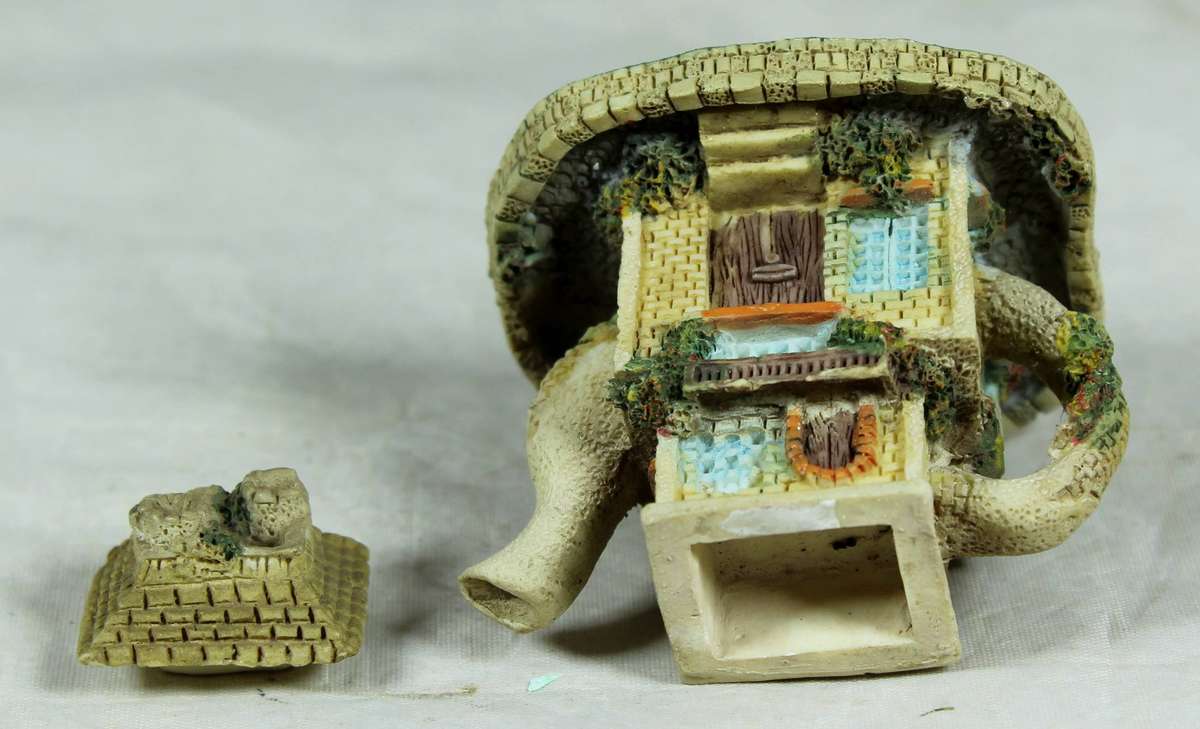 Miniature ornamental house in the shape of a tea kettle