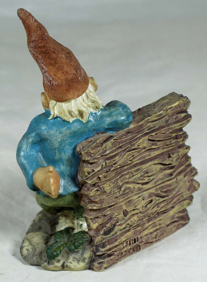 Small gnome leaning against a wall