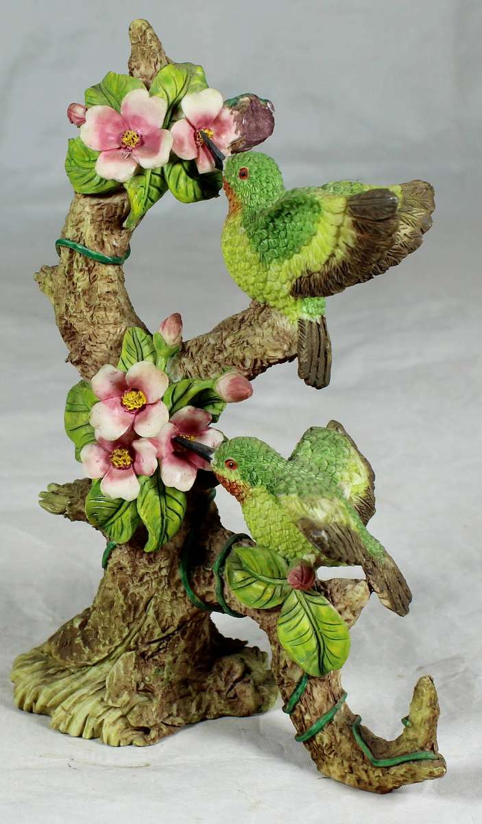 Molded bird on a tree, sucking nectar