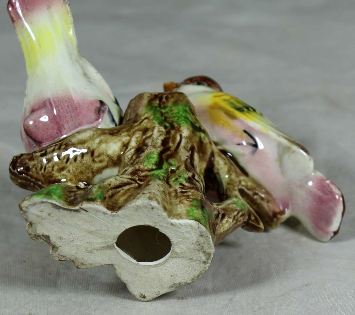 Pair of ceramic birds on a tree log