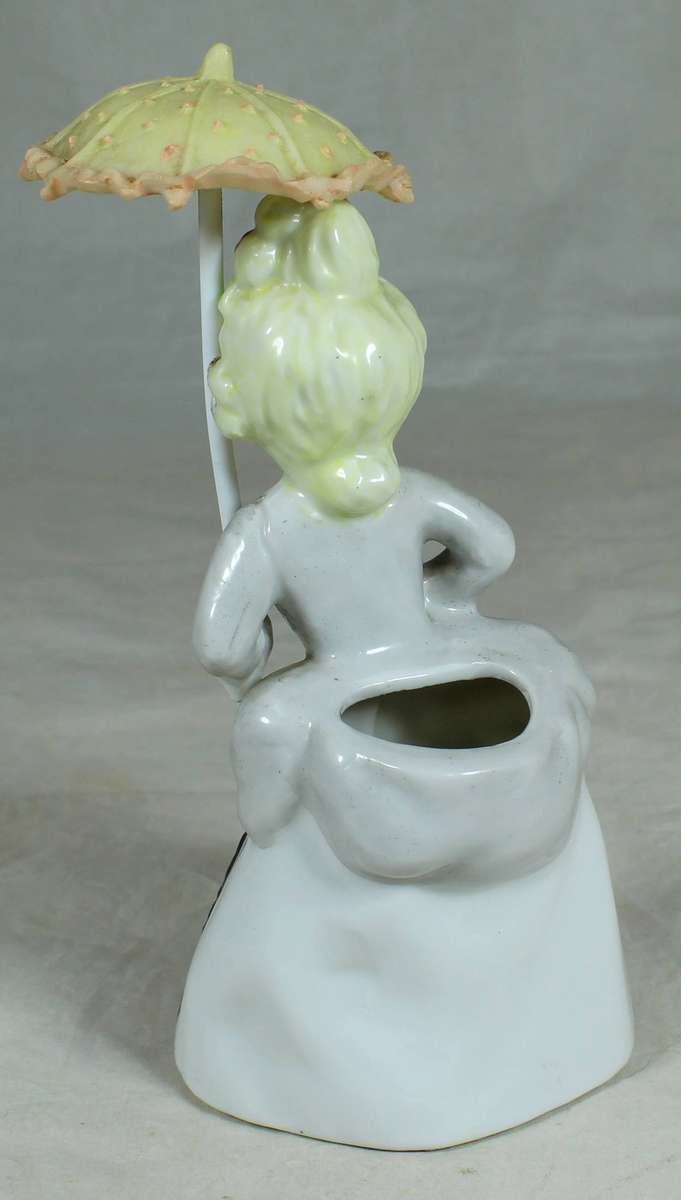 Ceramic girl in traditional dress with parasol