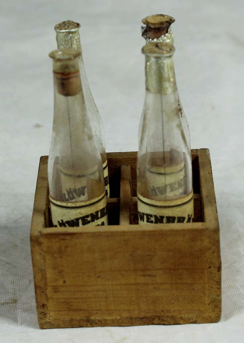 Set of 4 Miniature plastic Luwenbrau Beer bottles in a crate