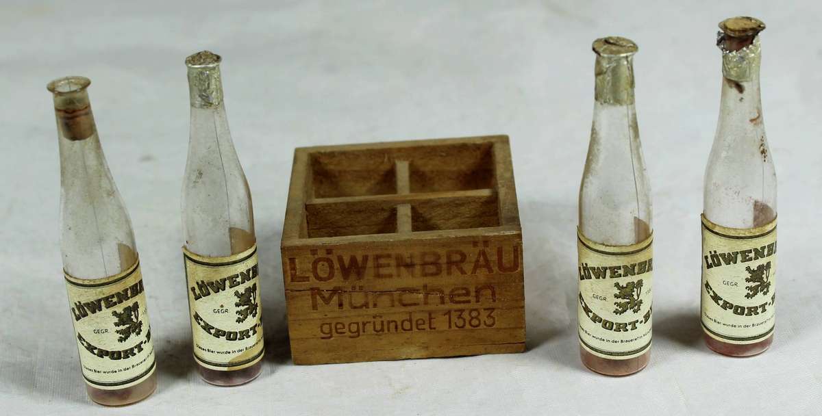 Set of 4 Miniature plastic Luwenbrau Beer bottles in a crate