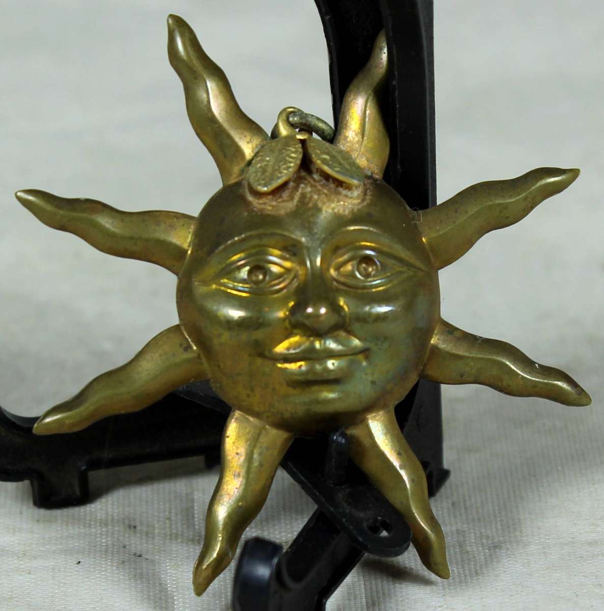 Miniature plated metal moon face pendant