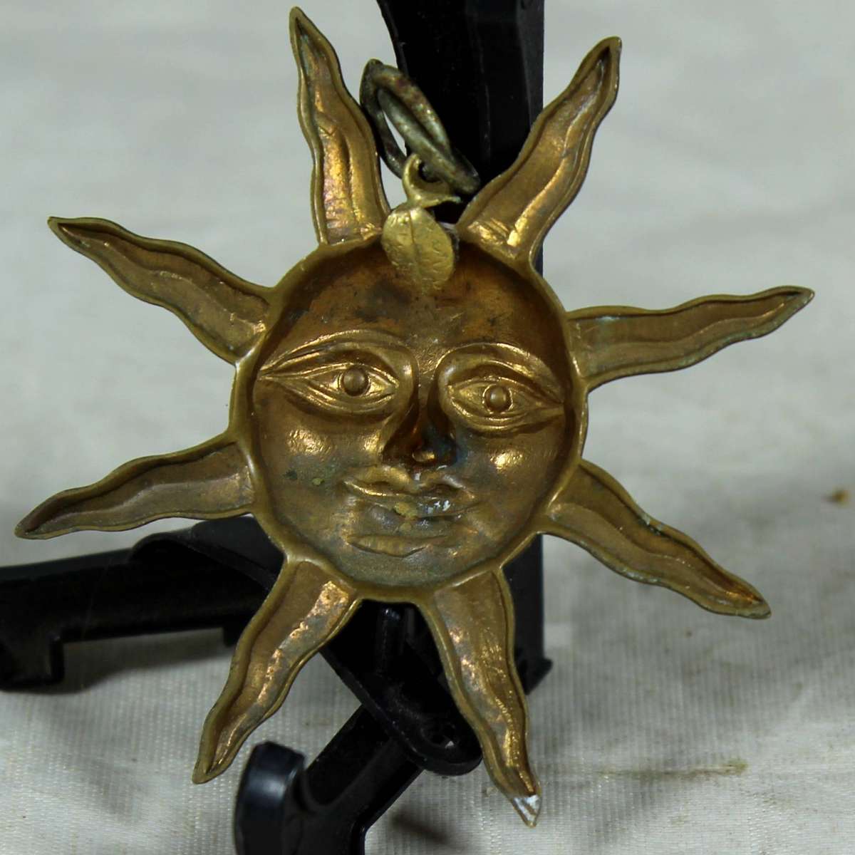 Miniature plated metal moon face pendant