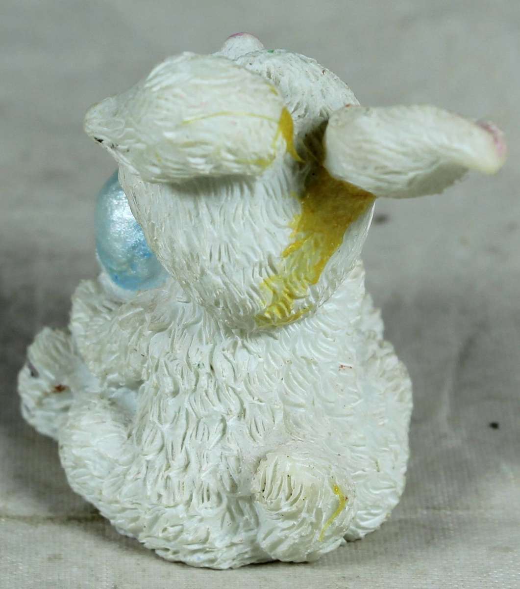 Miniature LaBell bunny holding a large Easter egg