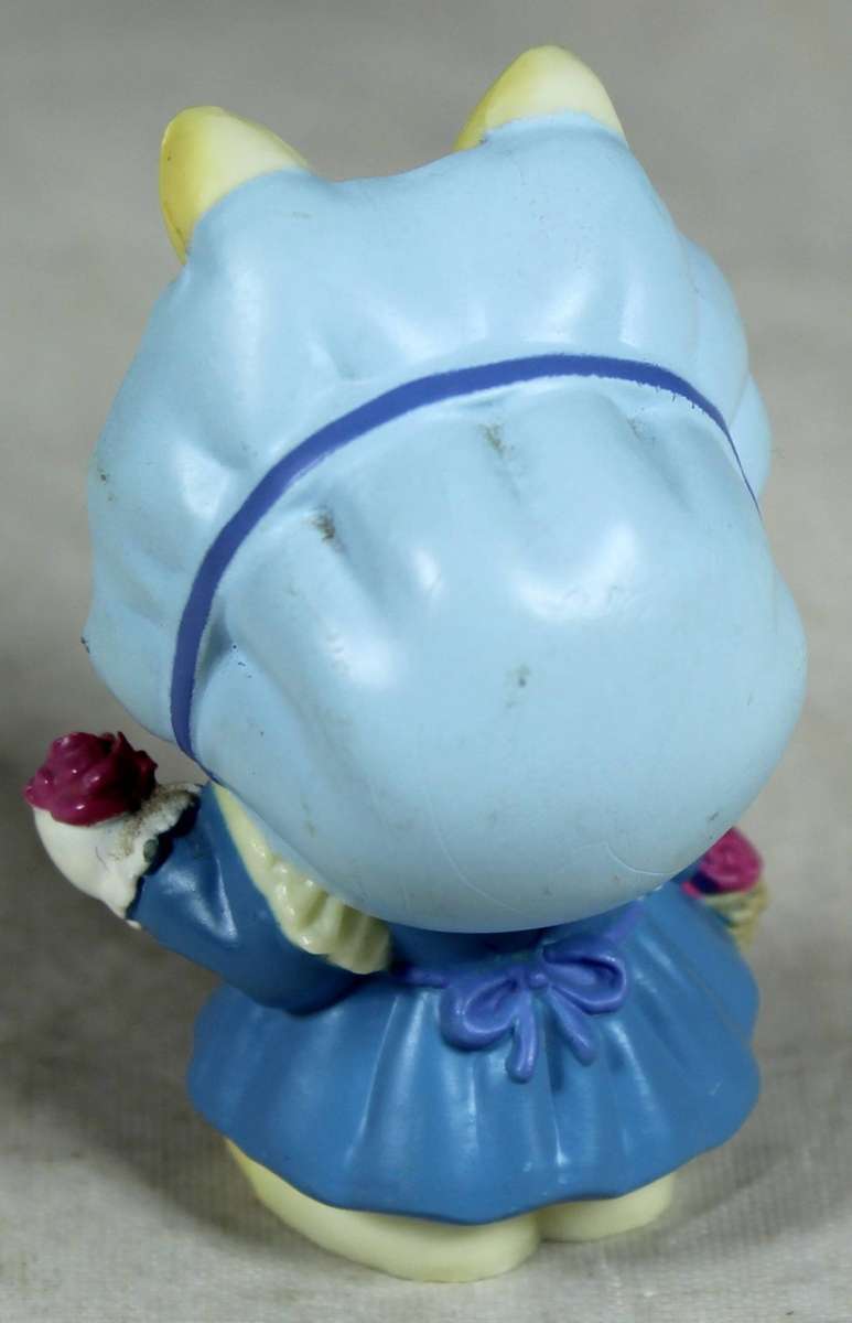 Miniature bunny baby holding a flower