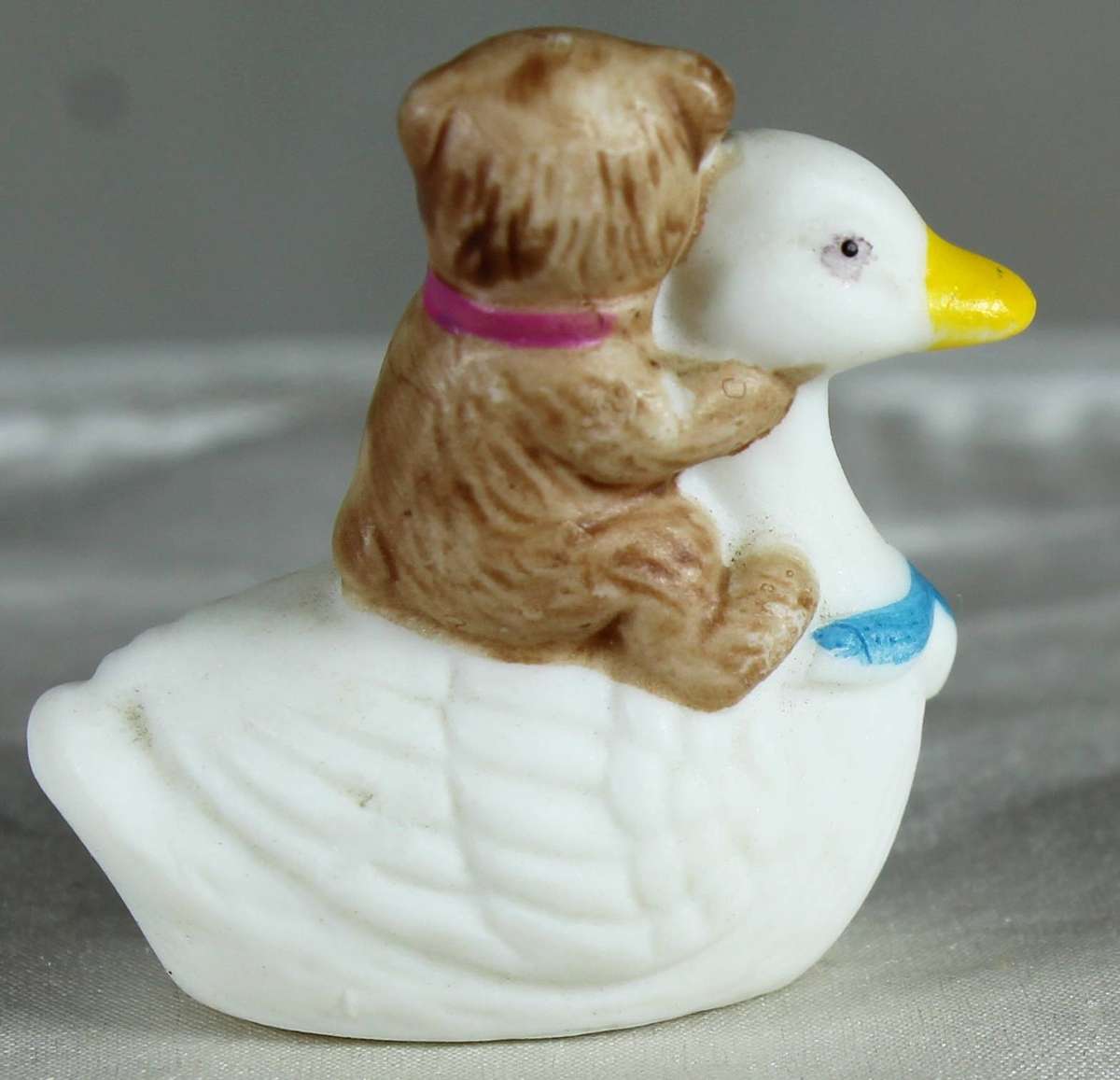 Miniature bear riding on a duck