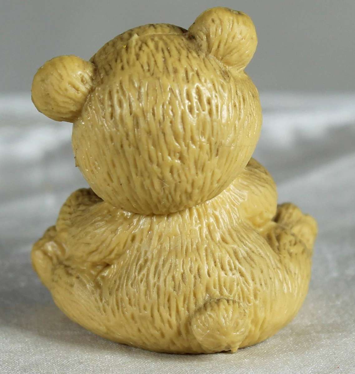 Miniature bear holding a candy cane
