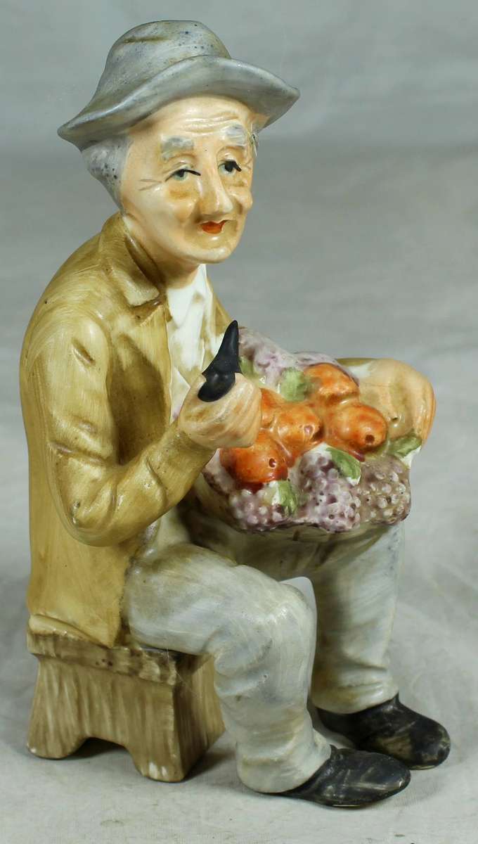 Ceramic figurine - old man smoking with a basket of fruit