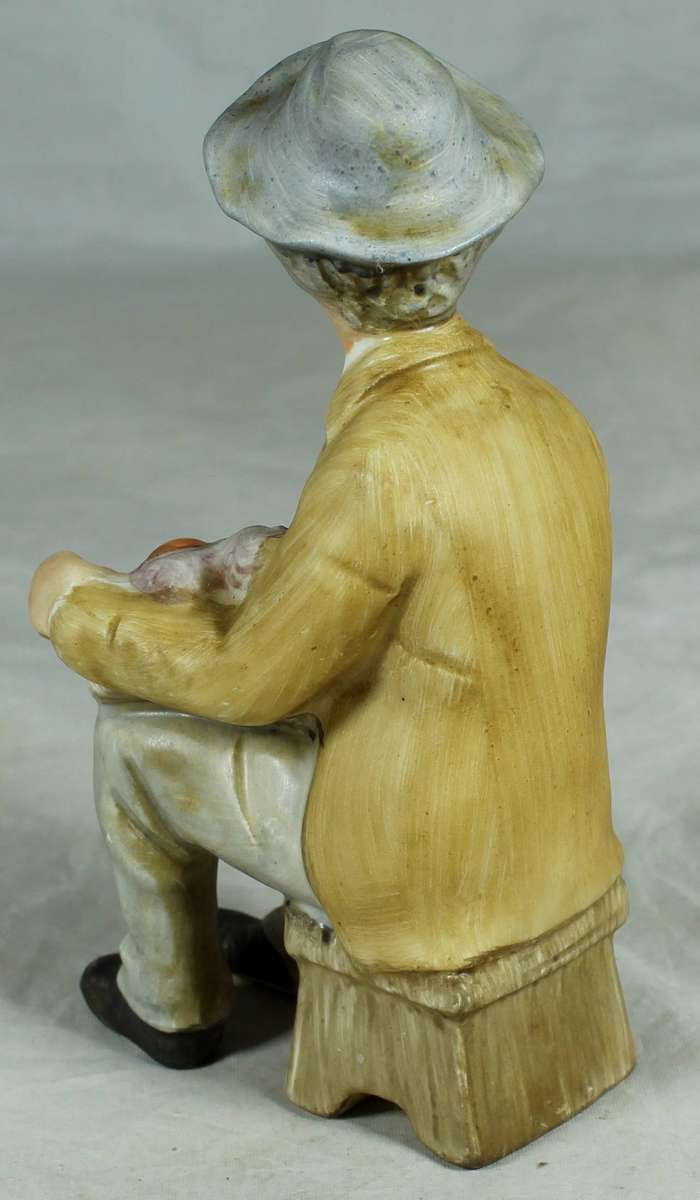 Ceramic figurine - old man smoking with a basket of fruit