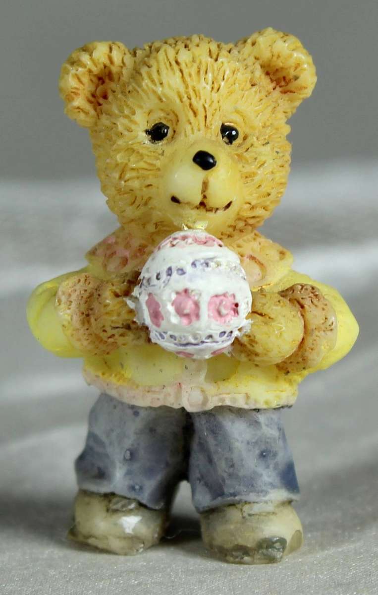 Miniature bear holding a ball