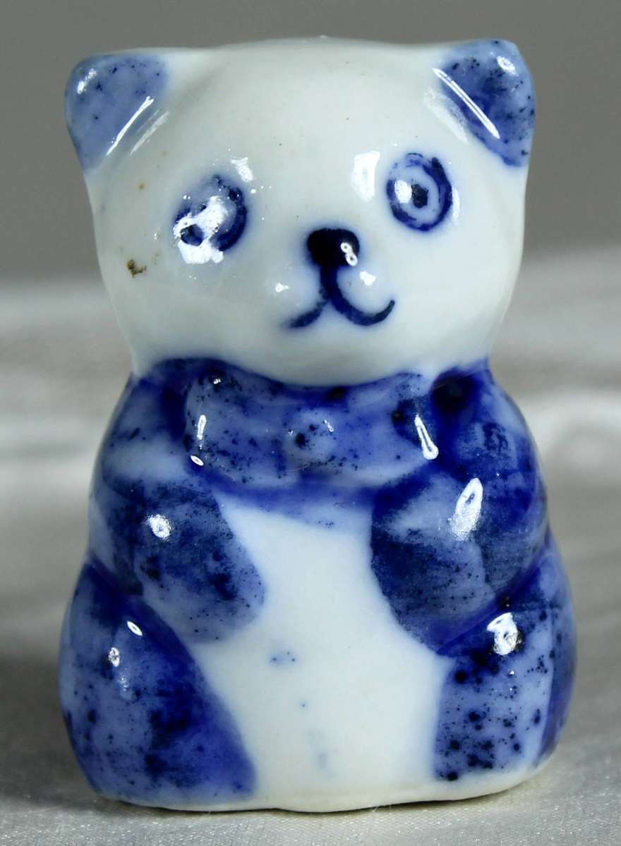 Miniature bear in a blue suit