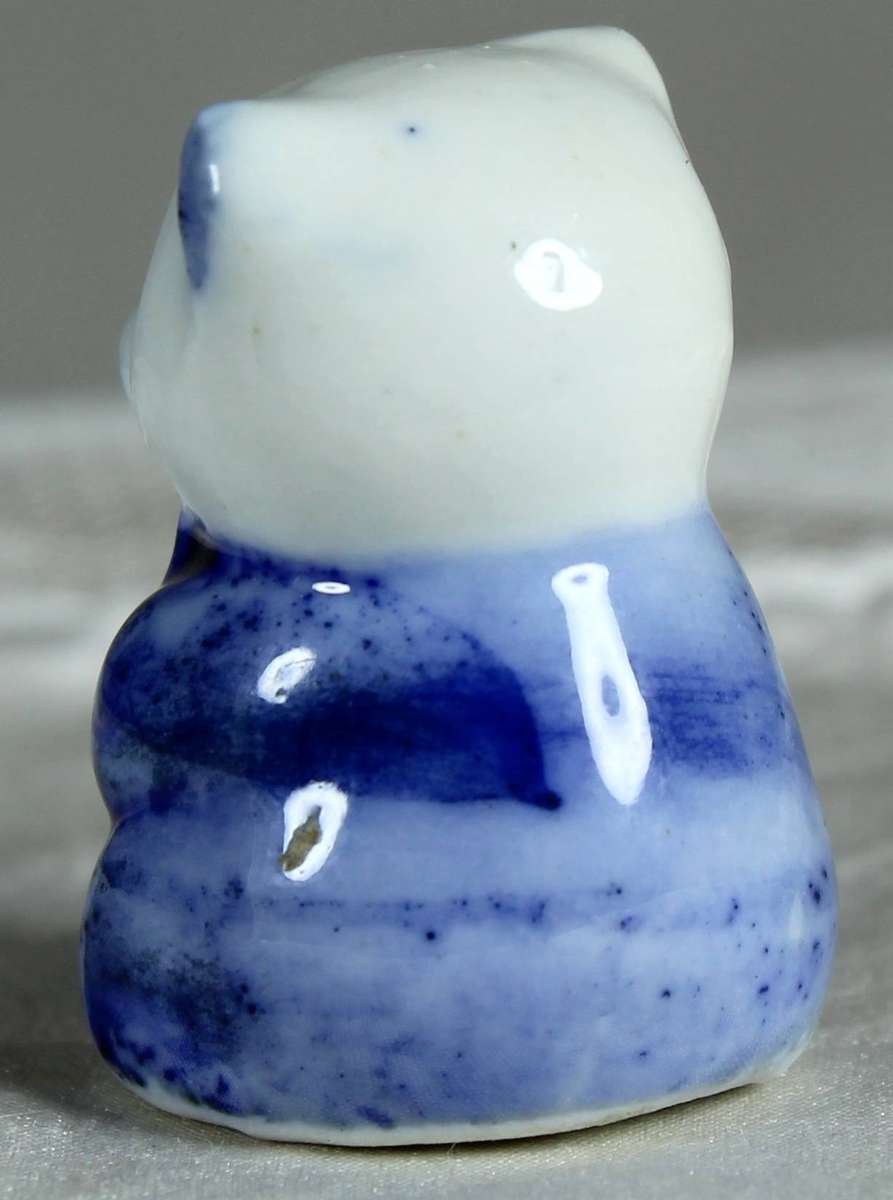 Miniature bear in a blue suit