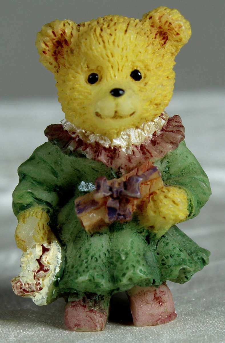 Mini miniature bear holding a present