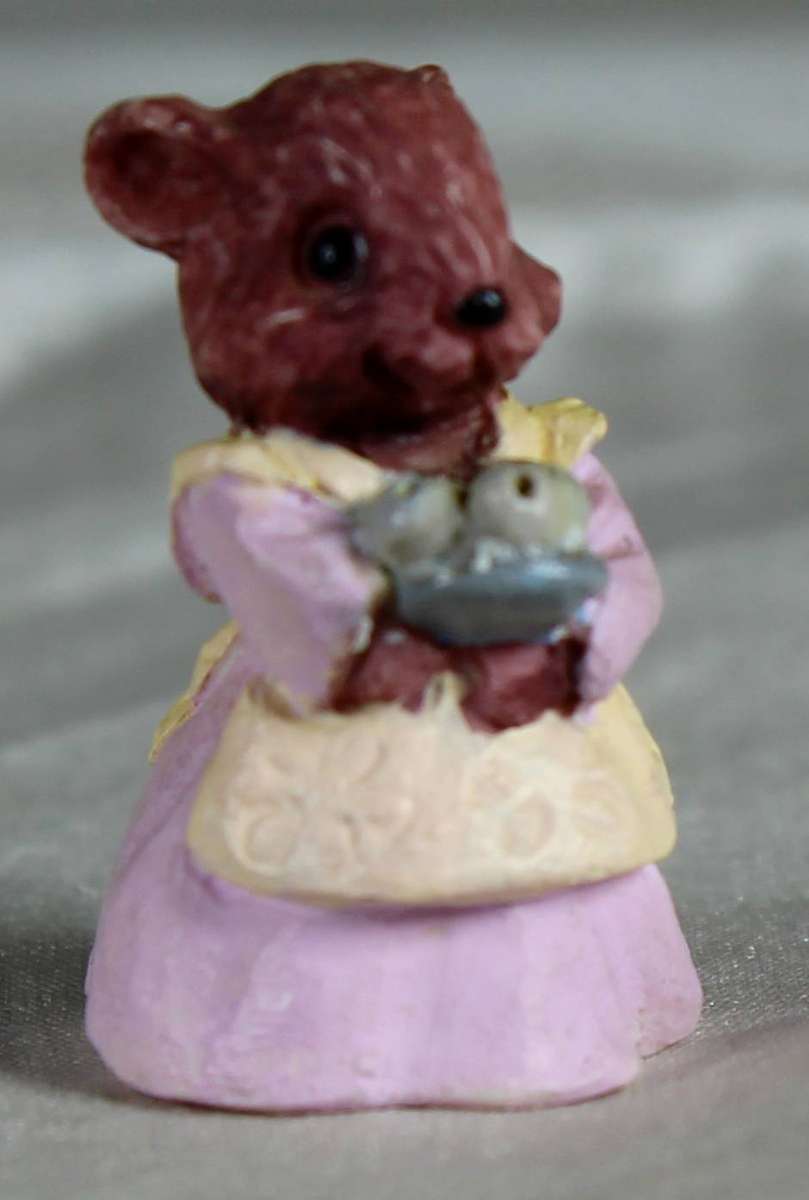 Mini miniature mouse carrying a bowl of fruit