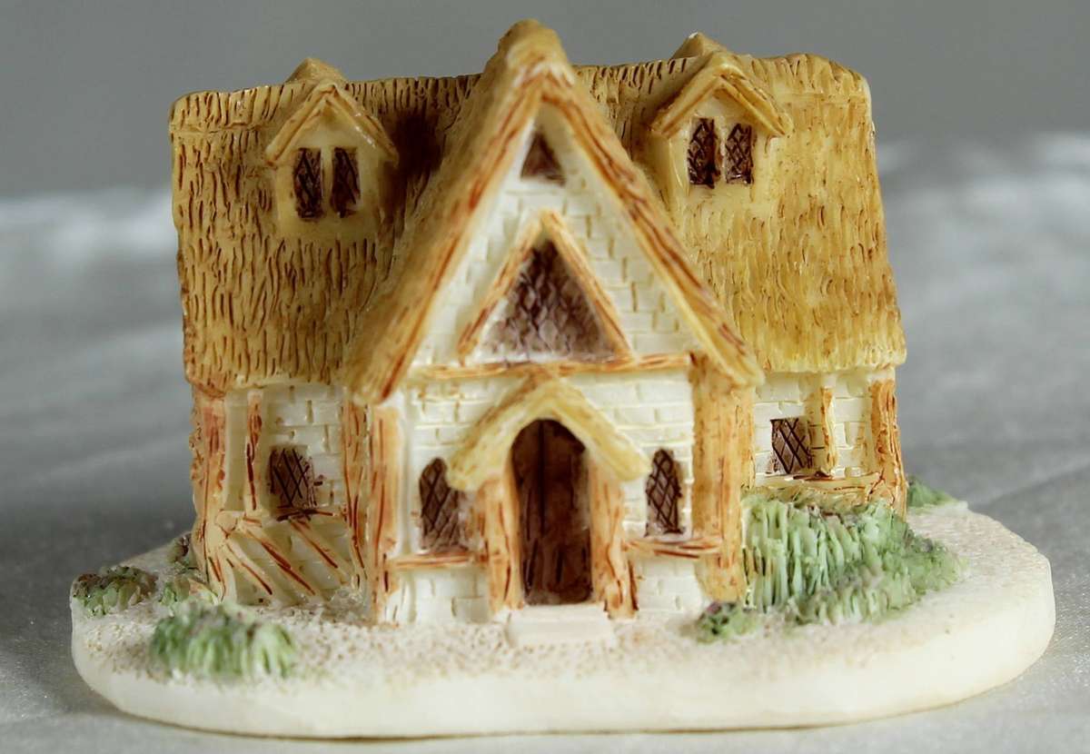 Miniature house with pitched roofs