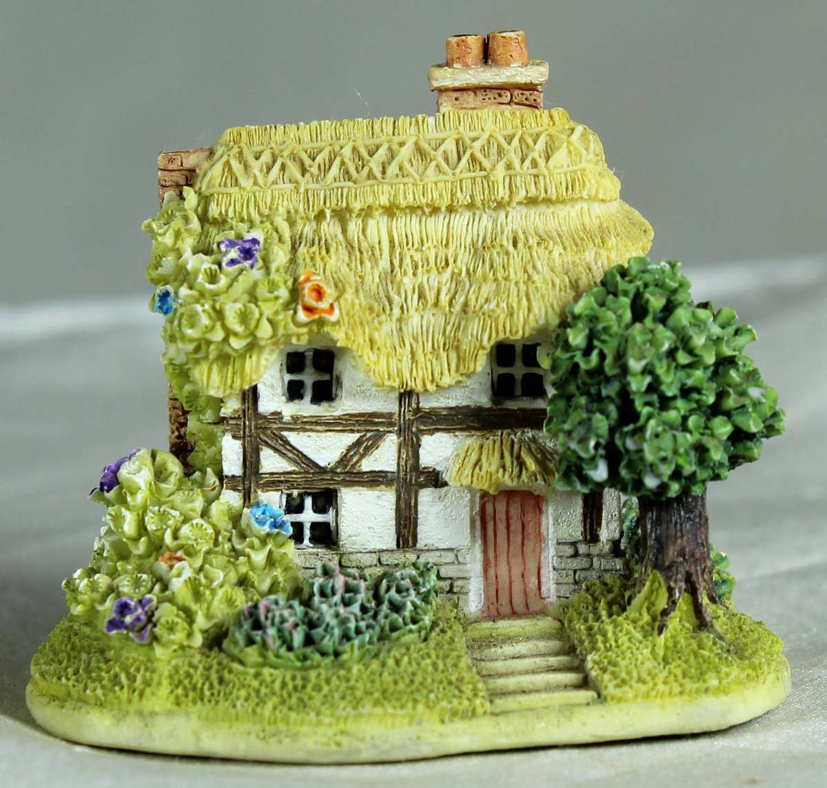 Miniature thatched house with tree