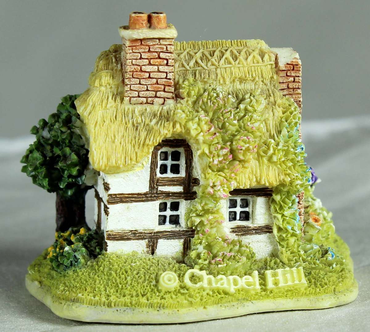 Miniature thatched house with tree