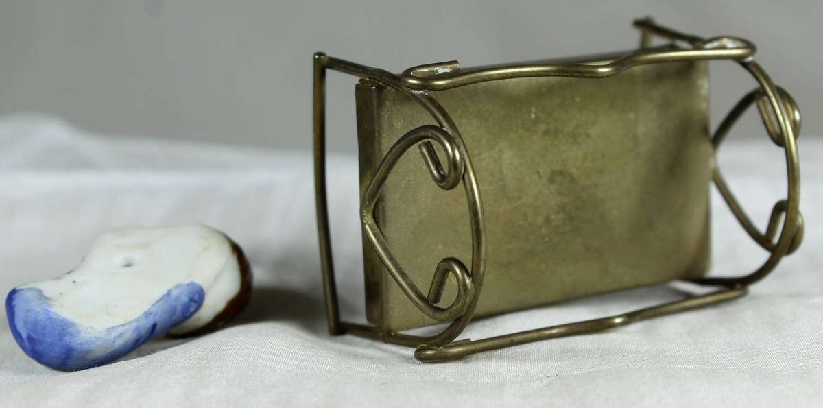 Mini miniature sleeping baby in a brass crib