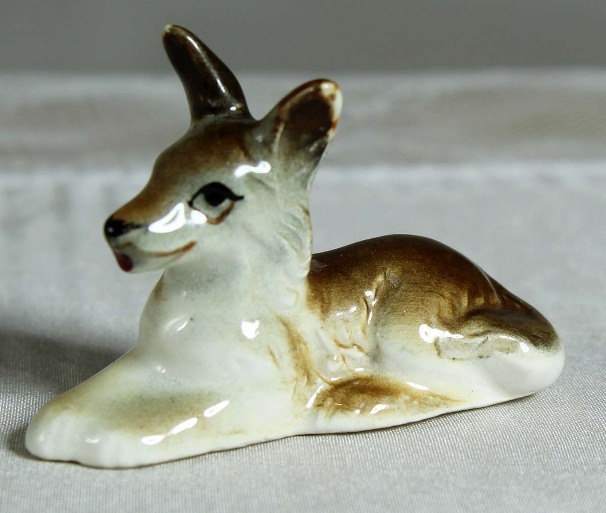 Miniature doe laying down