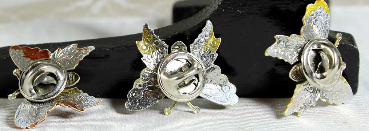 Miniature trio of metal pins