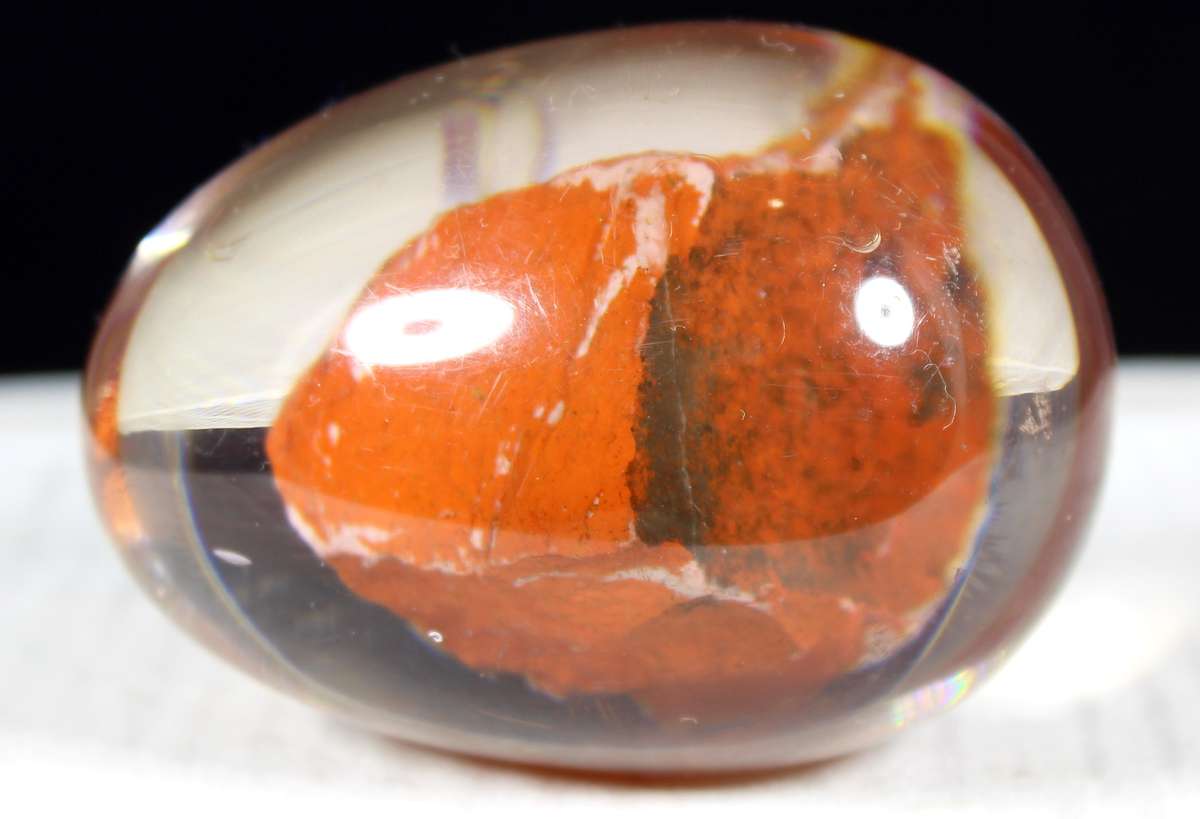 Glass egg paperweight with embedded semi precious stone