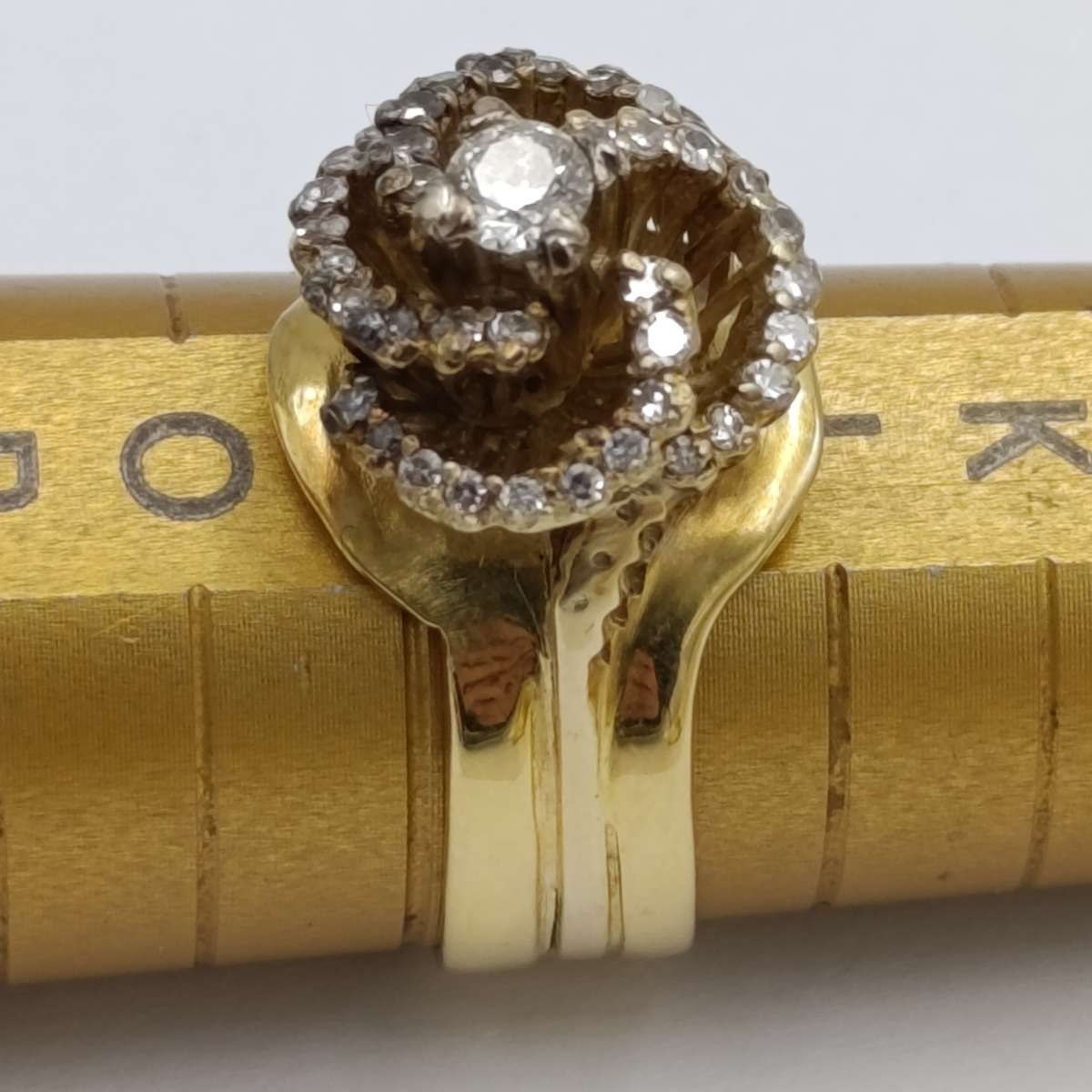 18kt Yellow Gold diamond ring with 0.20kt diamond surrounded by 40 small diamonds - weighs 8.4g