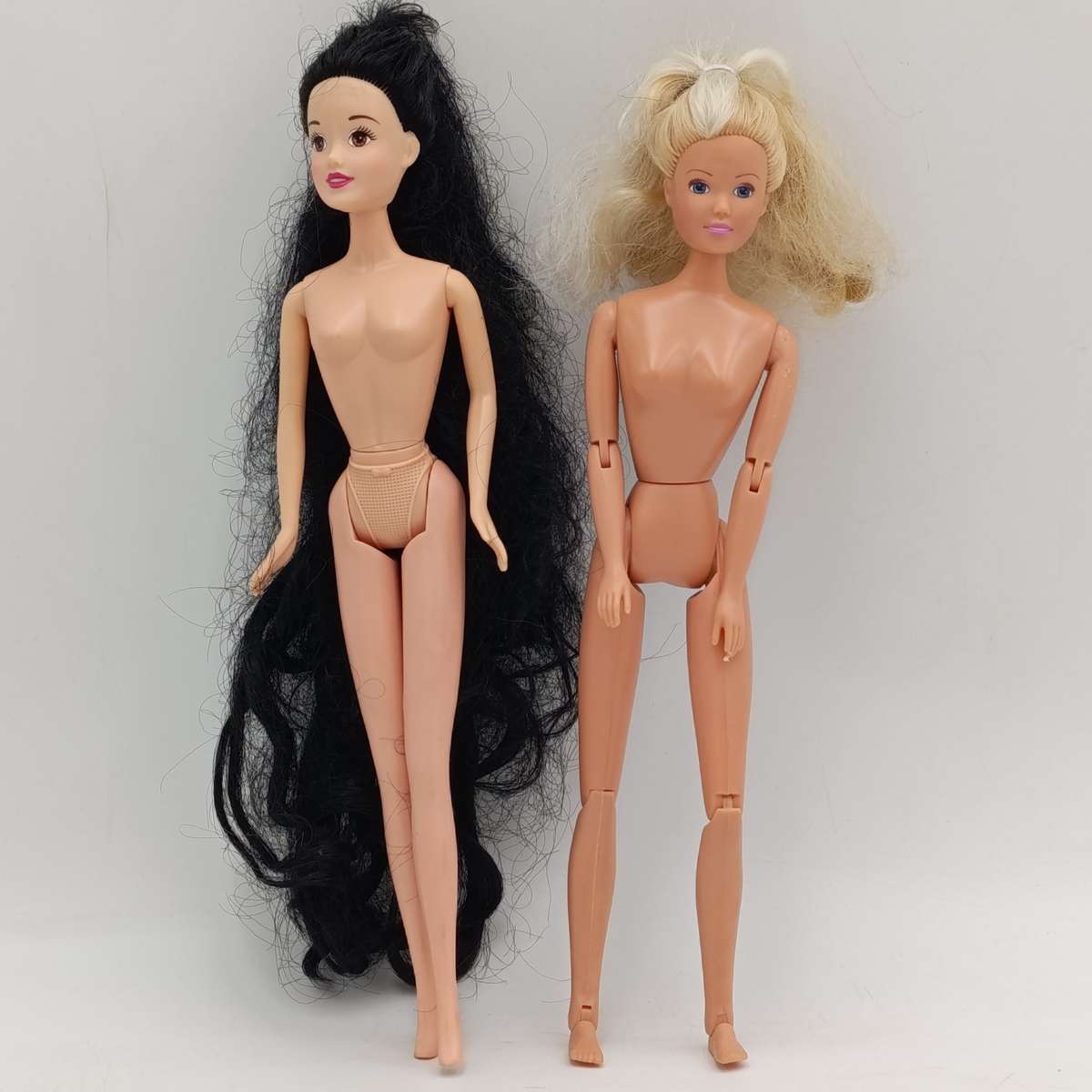 Two dolls with matted hair