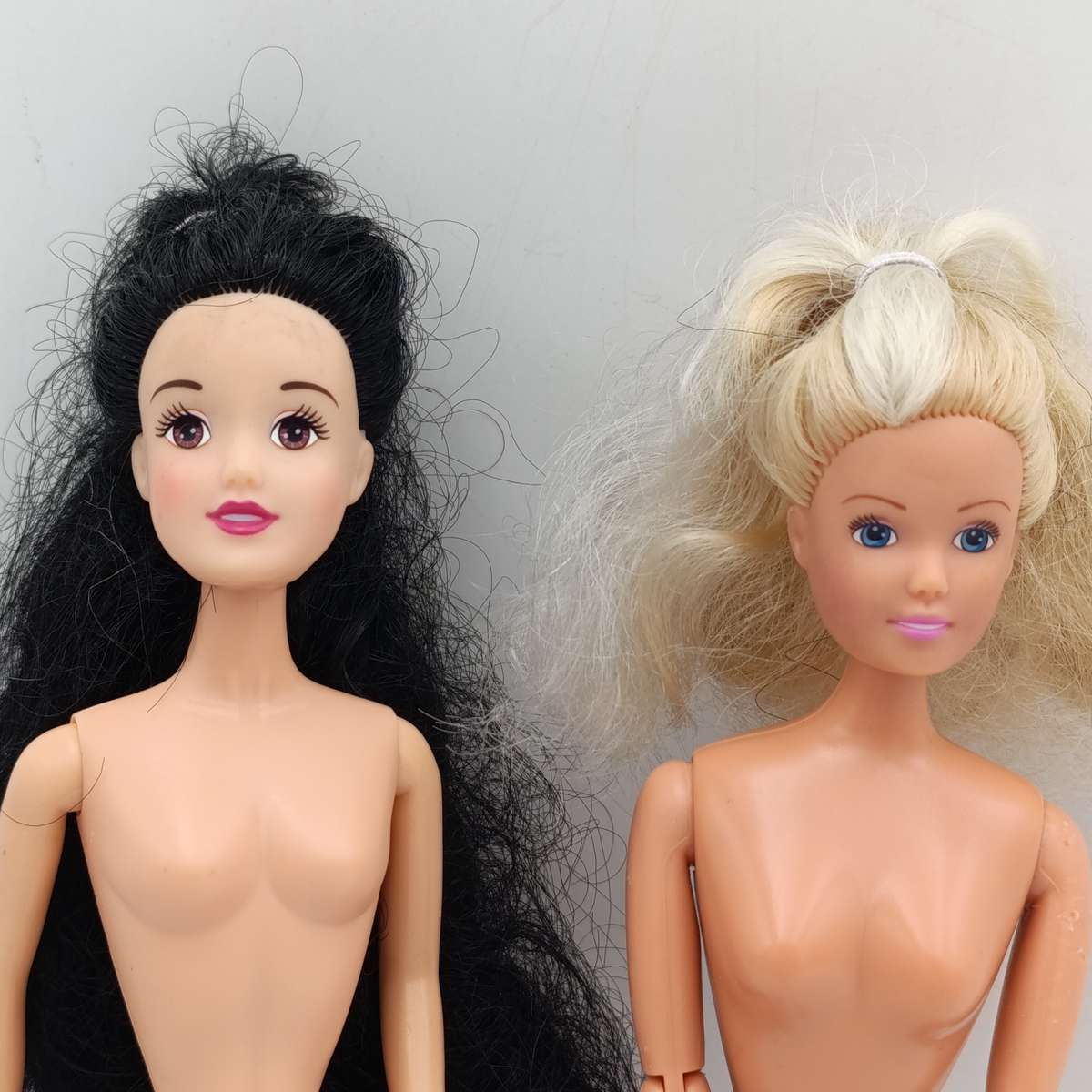 Two dolls with matted hair