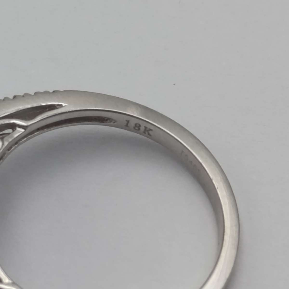 18kt White ring with blue stone surrounded by small diamonds - weighs 6.2 grams - size N 1/2