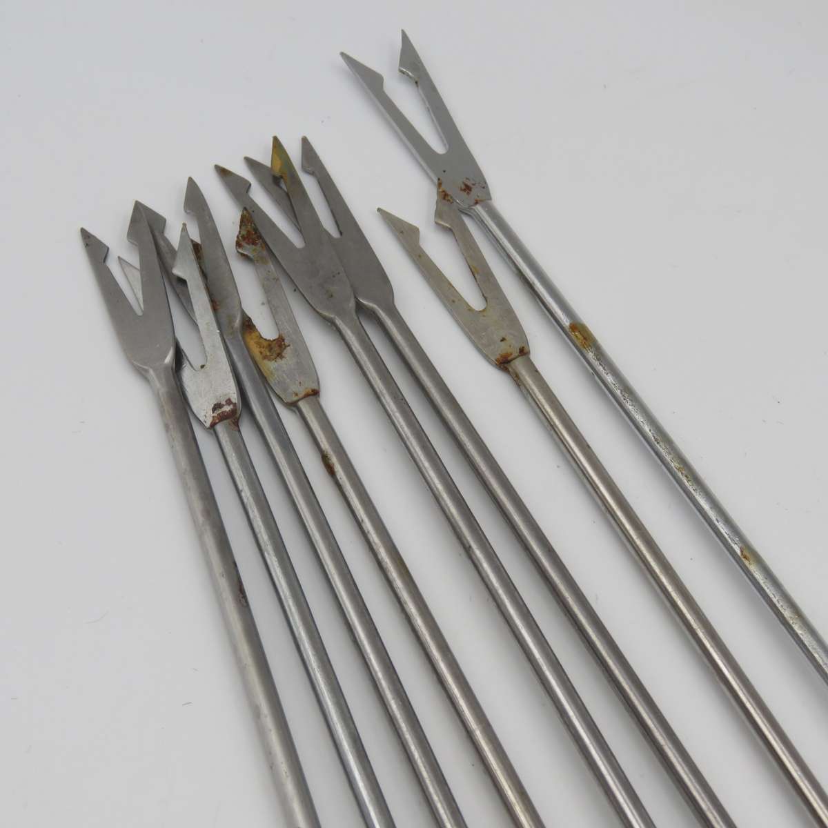 Vintage cast-iron fondue set with 8 forks