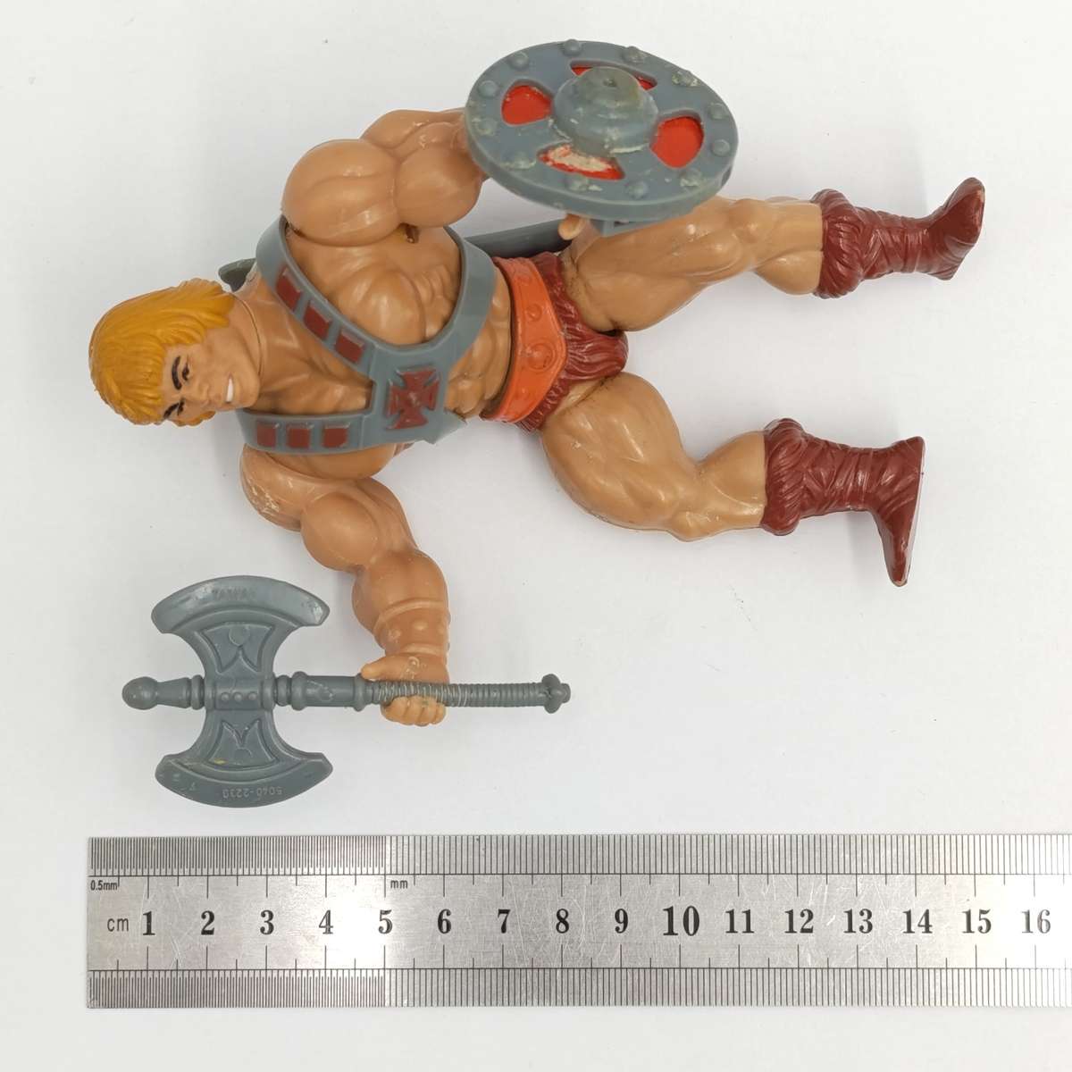 Vintage Masters of the Universe He-Man figurine with weapons and accessories